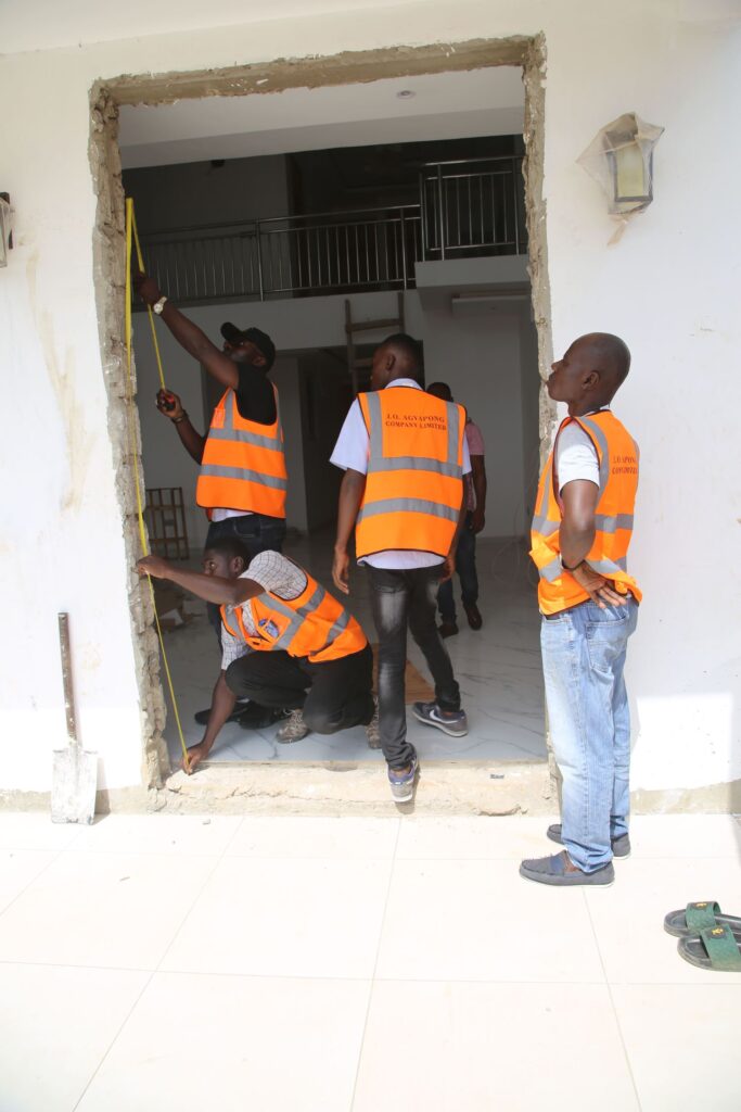 J.O Agyapong Team Fixing a Technical Door